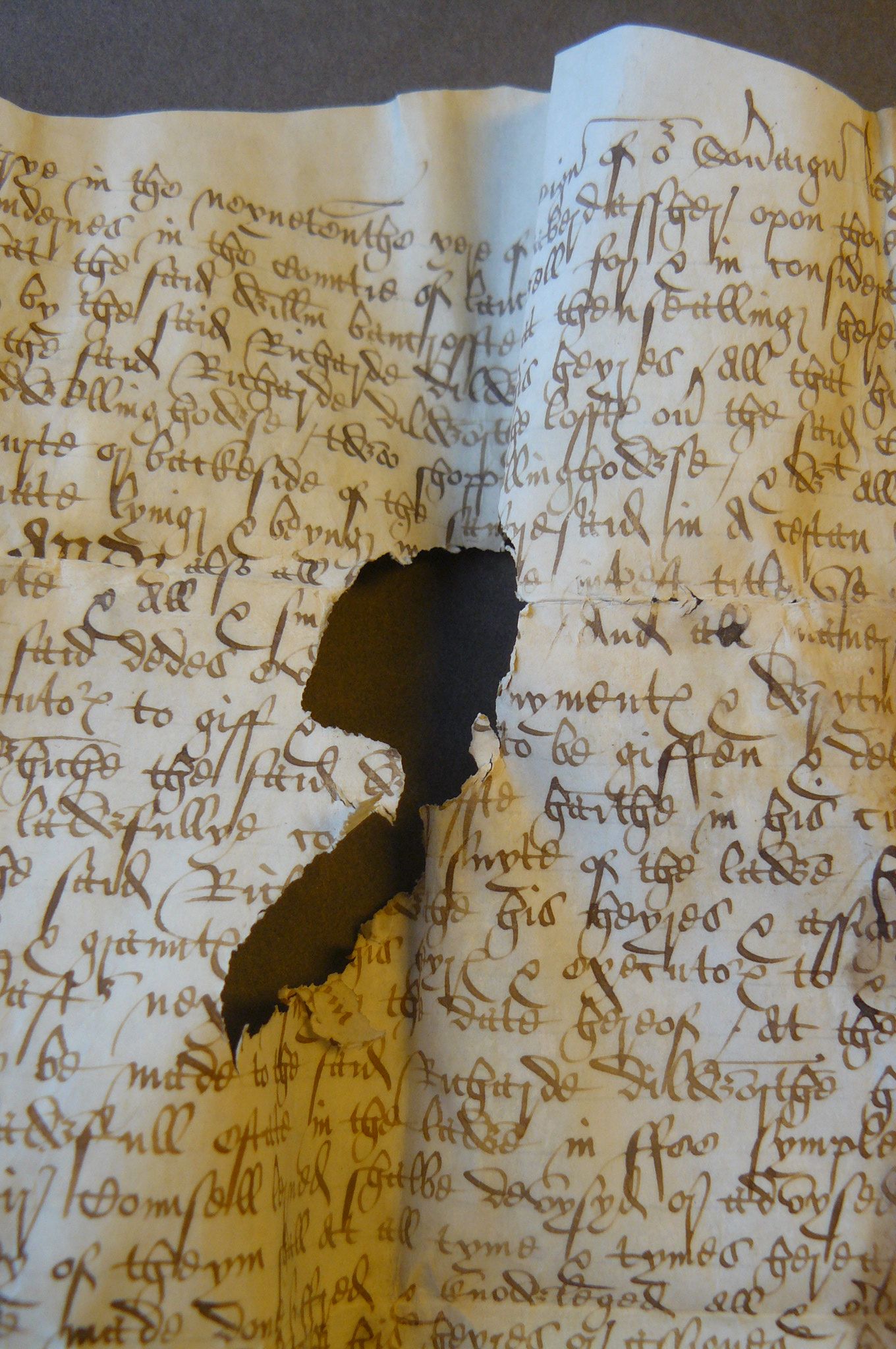 Image: Damaged parchment document from Yarburgh Muniments Lancashire Deeds YM. D. Lancs 13, 14th January 1576/7 (By permission of The Borthwick Institute for Archives)